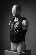 Premium black protective sports vest on minimalist grey mannequin, dramatic lighting