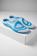 Luxury product shot of high-tech orthopedic insoles with blue polymer core on white box